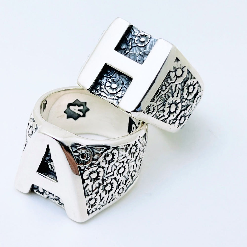 Handcrafted sterling silver floral initial ring with large letter front and flower pattern sides – personalized family ring by Atlas Jewelry