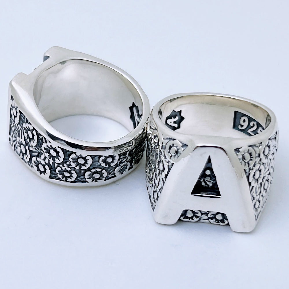 Handcrafted sterling silver floral initial ring with large letter front and flower pattern sides – personalized family ring by Atlas Jewelry